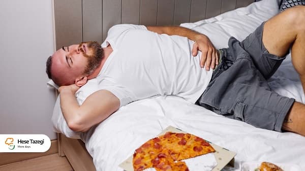 عوارض خوابیدن با معده پر چیست